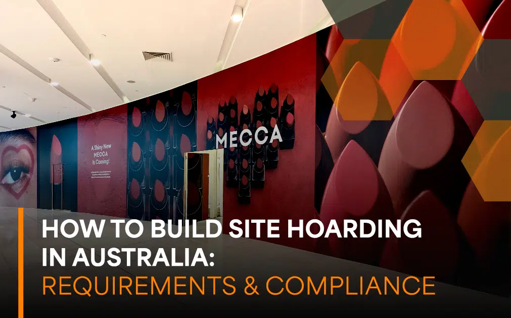 Retail construction site hoarding inside a shopping centre featuring large MECCA branding and graphics, with overlaid text “How to Build Site Hoarding in Australia: Requirements & Compliance,” highlighting commercial hoarding design and regulatory standards.