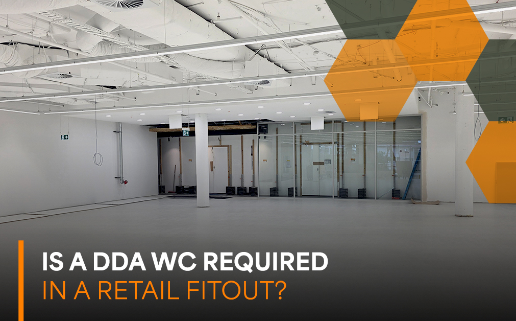 mpty retail fitout under construction with overlaid text "Is a DDA WC Required in a Retail Fitout?" representing Australian accessibility and DDA compliance requirements for retail projects.